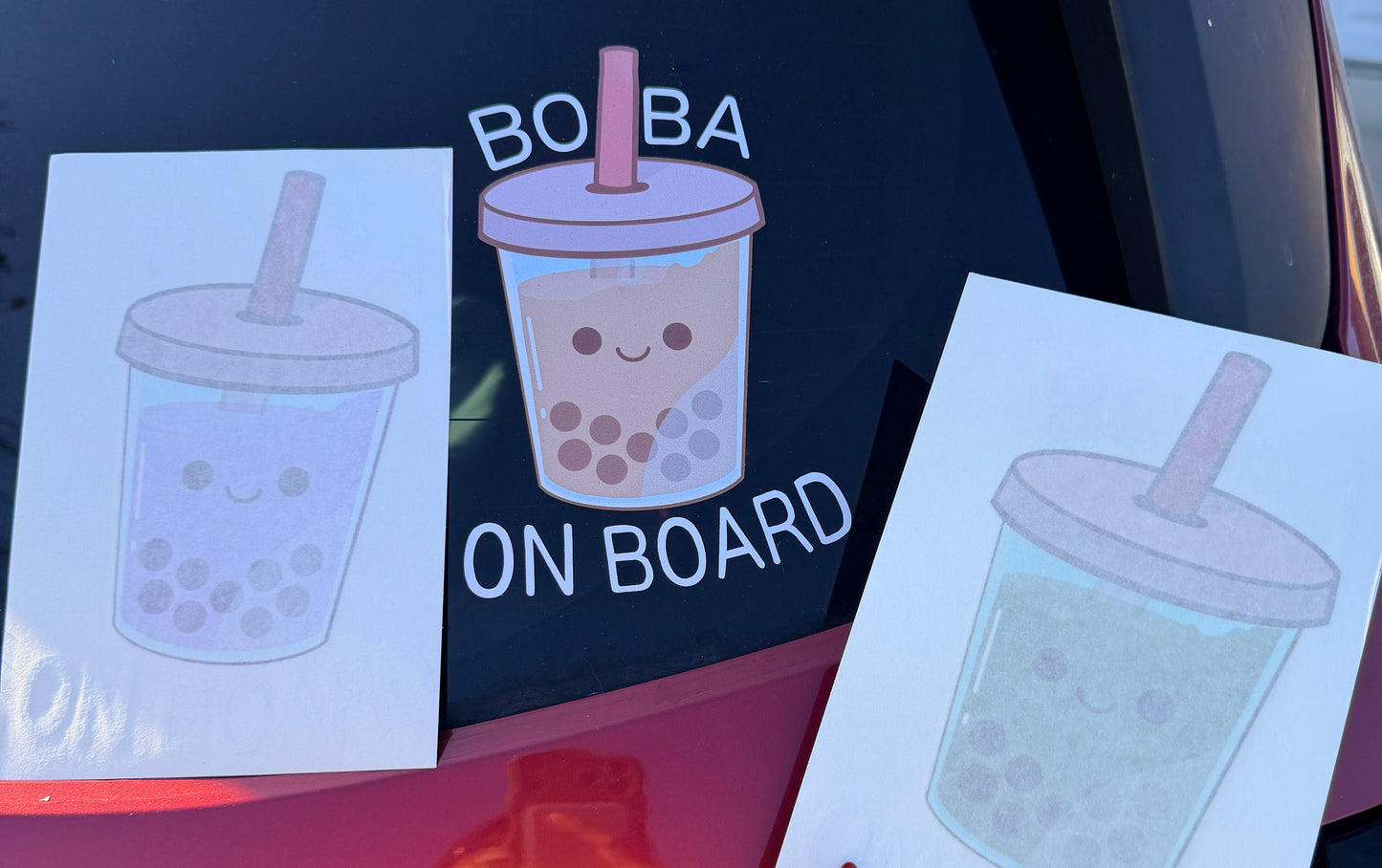 Bubble tea-themed car decals with 'Boba On Board' text on a car window.